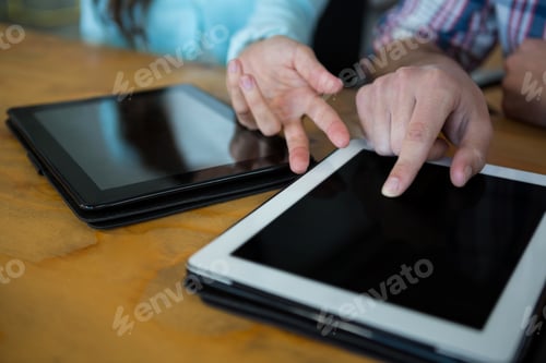 Preview: Business executives using digital tablet at desk