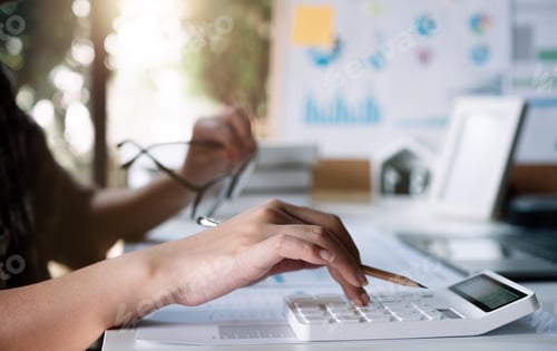 Preview: Women using calculator for calculate financial report at home