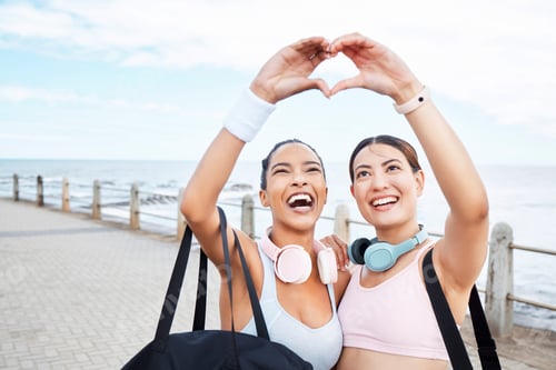 Preview: Hands, heart and fitness while woman friends gesture a hand sign outdoor during fitness or exercise
