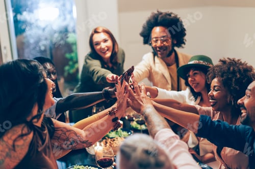 Preview: group of people giving high five at the dinner table