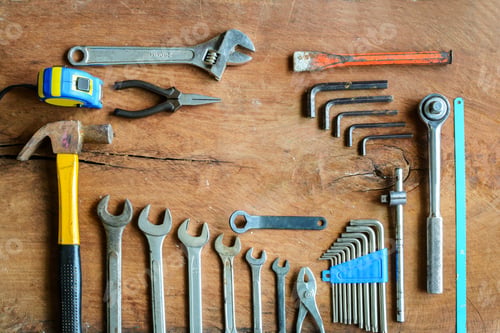 Preview: Set of work tools on old grunge wood background