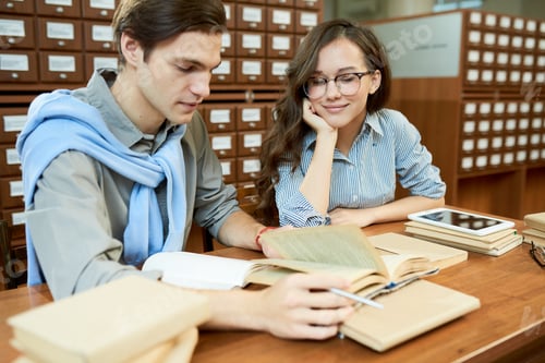 Preview: Content friends working on scientific project in library