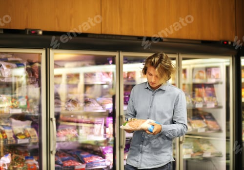 Preview: Man Choosing Frozen Food From A Supermarket Freezer