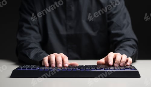 Preview: a person on his work place typing on the keyboard