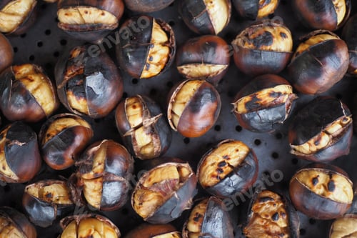 Preview: traditional Istanbul street food grilled chestnuts in a row