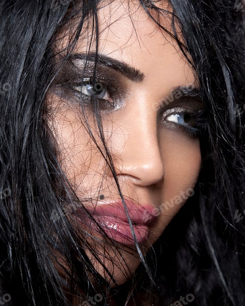 Preview: Close up of beautiful young woman's face with wet hair