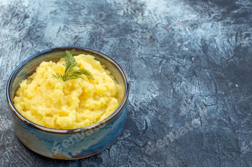 Preview: Top view of mashed potatoes served with dill on the right side on dark color background with free