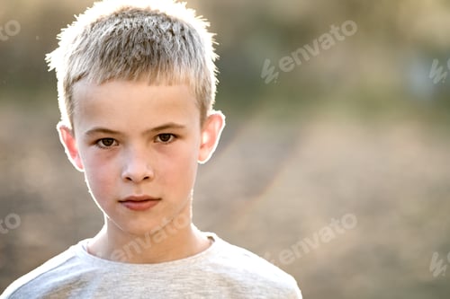 Preview: Portrait of a child boy outdoors on a warm sunny summer day.