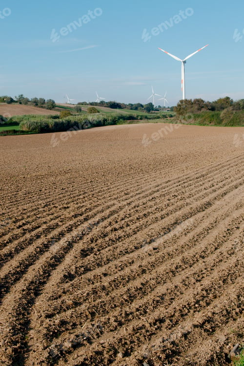 Preview: Cultivated fields with wind turbines for clean energy production