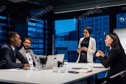 Preview: Businesswomen and men having discussion during office presentation