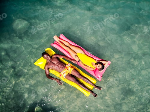 Preview: Diverse couple chilling on floats