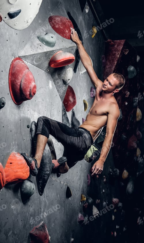 Preview: Man climbing on an indoor climbing wall.