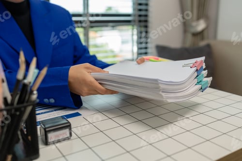 Preview: working in the private office, an employee, dealing with a lot of document on the desk