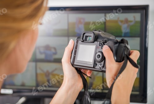 Preview: Freelance photographer woman at home office editing photos, blank camera screen