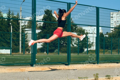 Preview: Beautiful Girl Sportswoman Exercising On A Sunny Morning At The Stadium