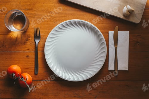 Preview: Porcelain plate and cutlery against a wood background with mediterranean elements