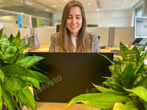 Preview: Millennial woman working with her laptop in a modern office, business woman, workplace, meeting