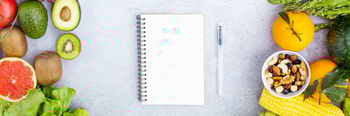 Preview: Flat lay top view of paper blank for weekly meal plan on gray background with fresh fruits and