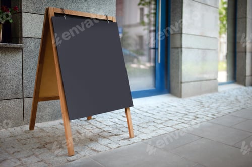 Preview: Blank advertising A-board near cafe. Mockup for design