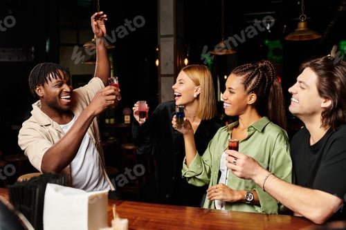 Preview: Young diverse colleagues celebrating and enjoying drinks at a corporate party