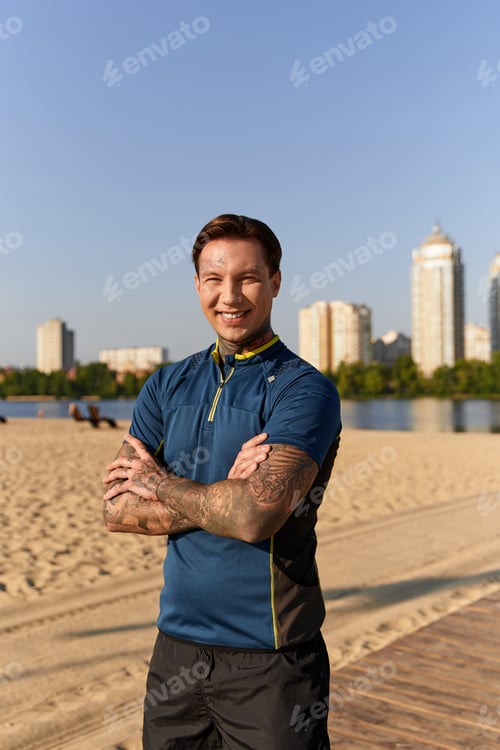 Preview: Handsome young man enjoys a sunny walk along the riverside with a cheerful smile