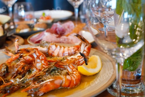 Preview: Plate of delicious grilled tiger prawns and assorted vegetables