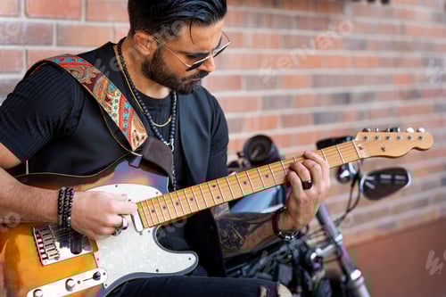 Preview: Cool Man Playing Guitar near a Motorcycle