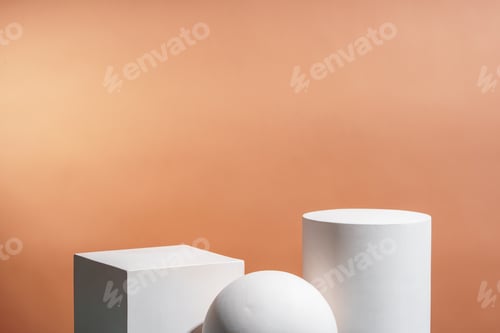 Preview: White geometric shapes arranged stylishly on a soft peach background in a minimalist setting