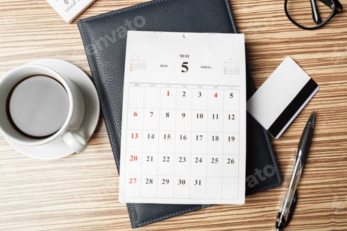 Preview: Spring calendar on desk with coffee cup and pen displays date and month clearly