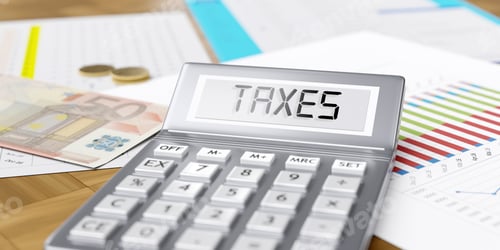 Preview: Taxes word on calculator display. Euro money and business reports on office desk