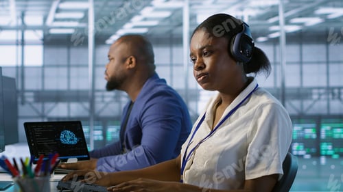 Preview: Woman in server hub listening music while ensuring optimal system performance