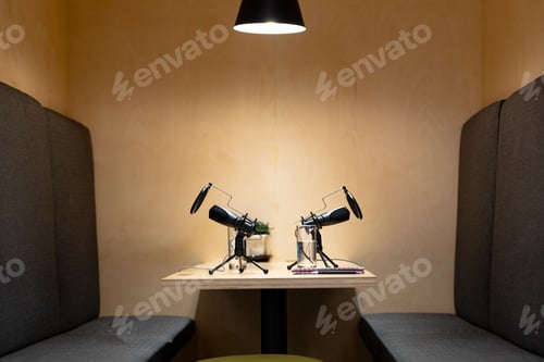 Preview: Office desk with microphones, documents, laptop computer, glasses of water and smartphone