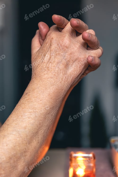 Preview: Hands of an old woman folded for prayer.