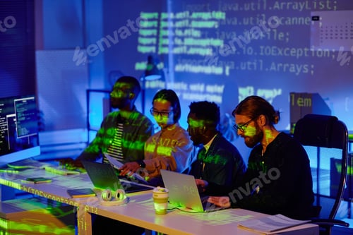 Preview: Several young contemporary software developers sitting in row