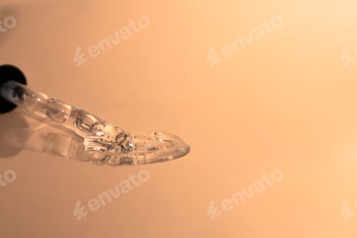 Preview: Glass dropper with transparent cosmetic liquid, hyaluronic acid, peptide on a plain background