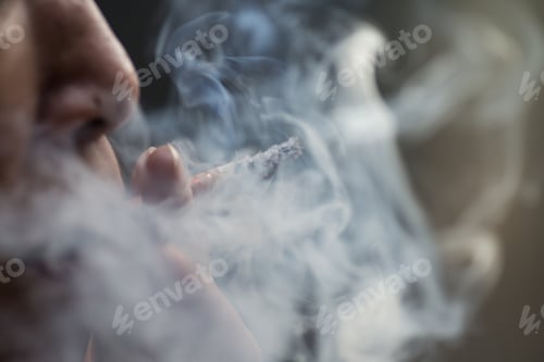 Preview: Selective focus shot of a female smoking cigarets - the concept of addiction