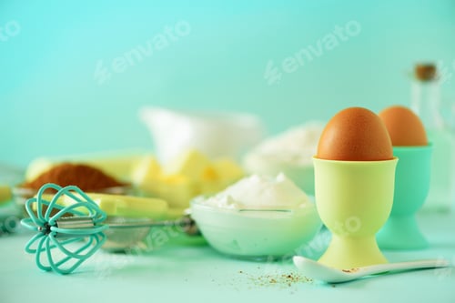 Preview: Turquoise cooking utensils on yellow background. Food ingredients. Macro of eggs. Cooking cakes and