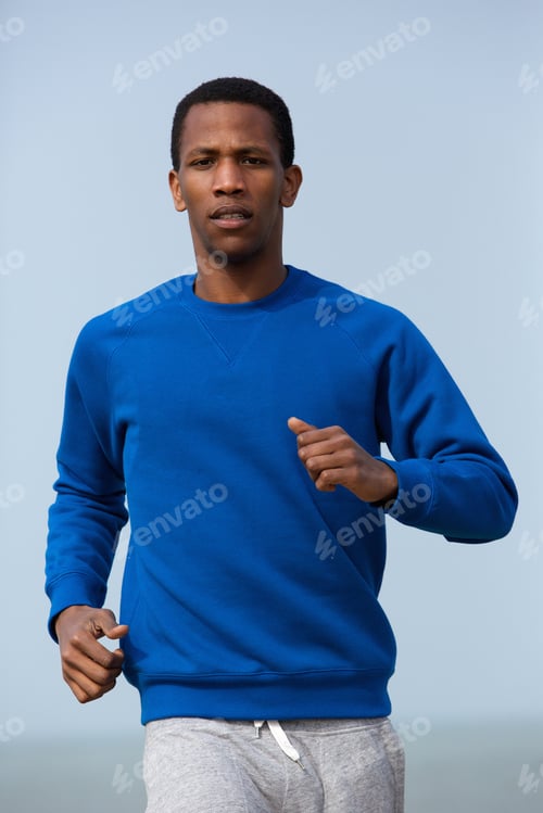 Preview: Portrait of a young athletic man jogging