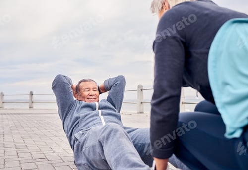Preview: Fitness, exercise and sit ups with a senior couple training outdoor together for an active lifestyl