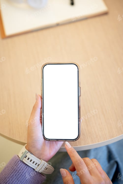 Preview: Woman hand holding smartphone finger pointing at white screen watching reading sitting at cafe table