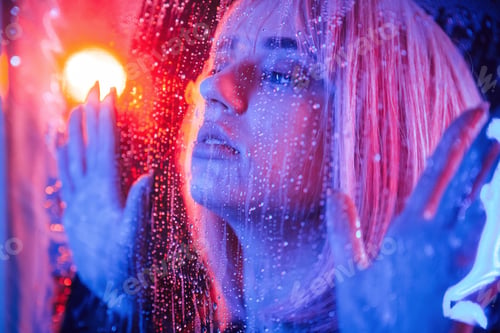 Preview: calm facial expression. Stylish woman with white hair is behind wet transparent plastic sheet