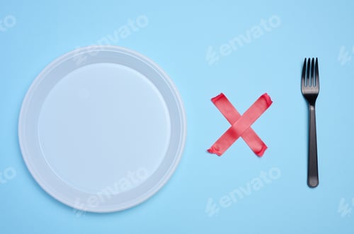 Preview: Empty white plastic plate and plastic fork is attached with red adhesive tape on a blue background