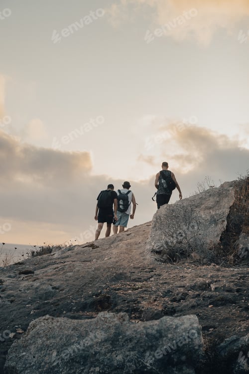 Preview: Men Hiking Up Rocky Hill Near the Coast