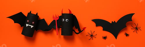 Preview: Paper bats on orange background, top view