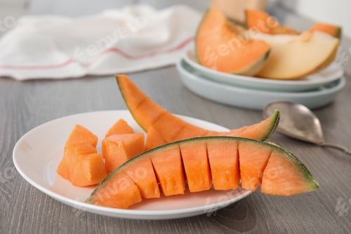 Preview: Slices of ripe cantaloupe melon on wooden table