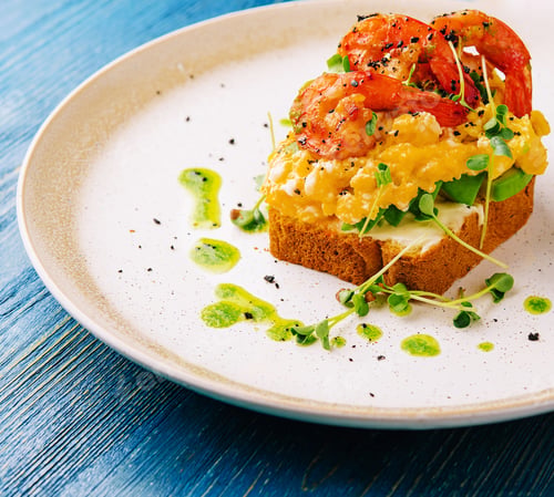 Preview: Scrambled eggs with avocado and shrimps on plate