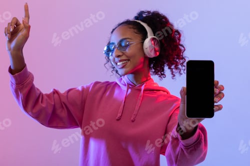 Preview: Happy lady dancing with phone and headphones