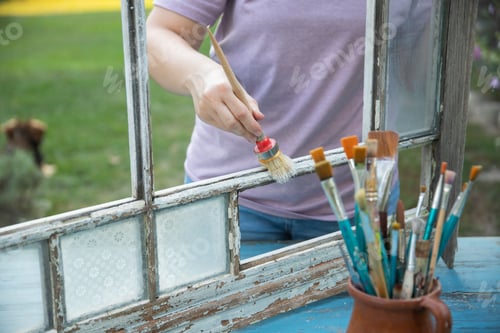 Preview: Painting a wooden vintage window outdoors, an eco-friendly re-use business.