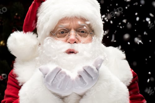 Preview: Portrait of Santa Claus blowing snowflakes from hands