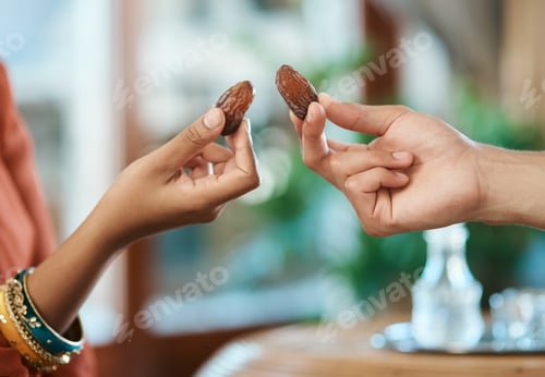 Preview: Breaking my fast with family. Shot of a muslim family breaking their fast with dates.